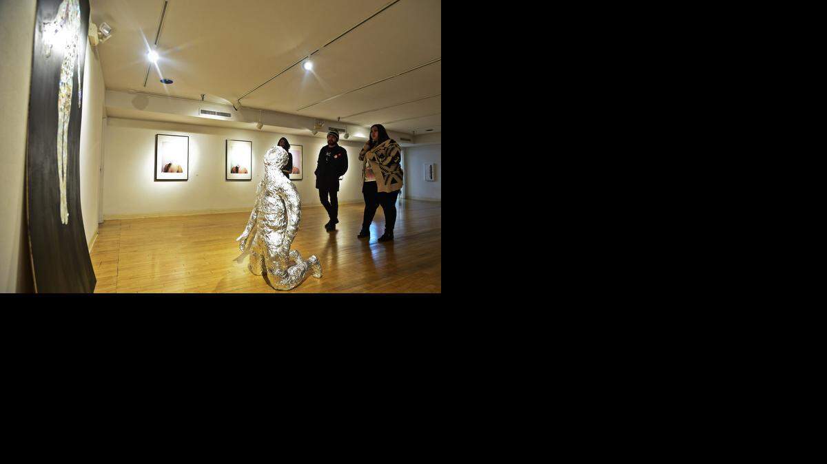 
Guests view artwork from Merced artist Martin Castro’s exhibit titled “Between Spaces” during a reception for a new gallery at the Merced Multicultural Arts Center’s Arbor Gallery located at 645 W. Main St. in downtown Merced on Thursday. The reception featured new, as well as established, artists, whose work will be on display through Jan. 9.
