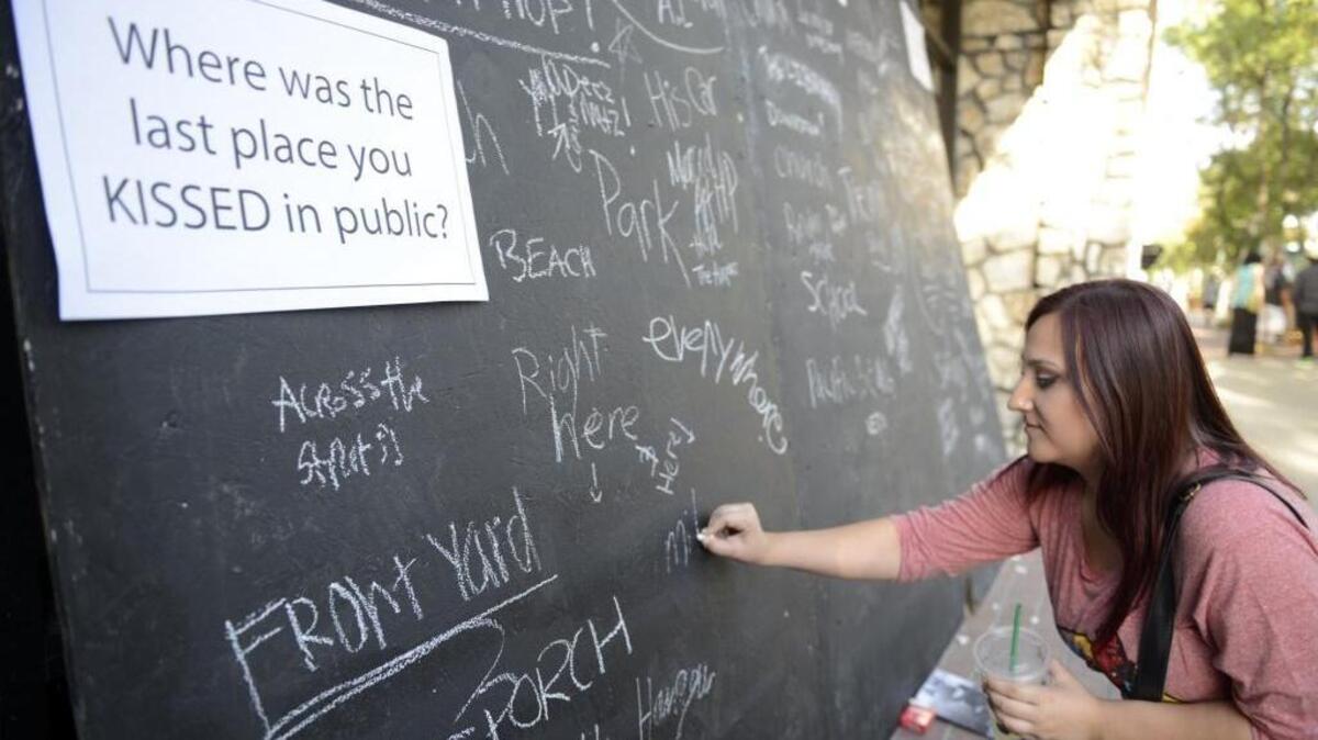 
Lauren Weaver, 18, of Merced answers a question asked by one exhibit at the Merced Art Hop in July in downtown Merced. 
