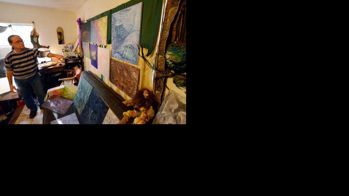 
Dob Francise, 52, gestures to some of his paintings hanging in his living room – which doubles as his studio – in Merced on Wednesday. He is the featured artist for Art Hop, which runs from 5 to 9 p.m. Saturday in Merced’s downtown.
