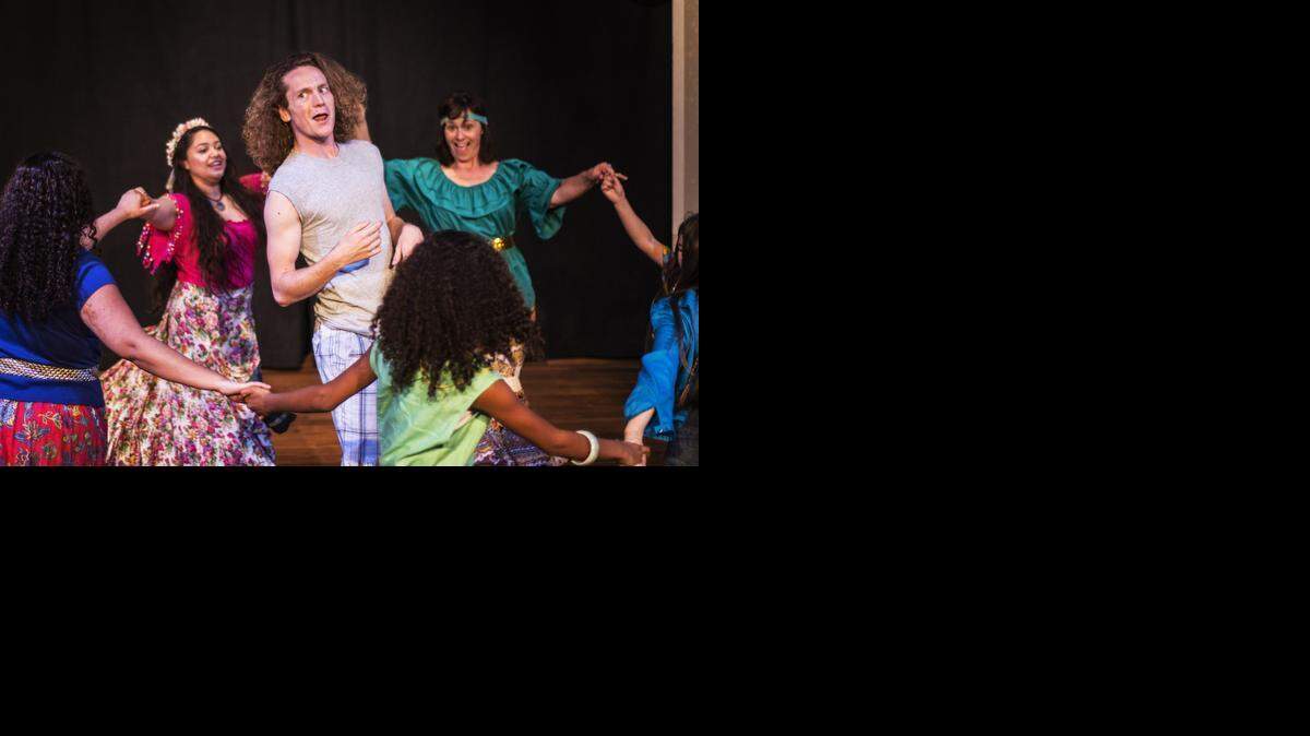 
Aaron Bremner, performing as Autolycus, sings as he is surrounded by children of Sicilia and Bohemia during a dress rehearsal for the Merced Shakespearefest presentation of “The Winter’s Tale.“

