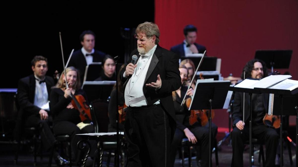 Merced Symphony director Henrik Jul Hansen talks to the audience about the music in the program in 2013 at the Merced Symphony Pops Concert at the Merced Theatre Art Kamangar Center in downtown Merced. Hansen, an accomplished conductor, pianist, professor and composer who led the Merced Symphony for more than a decade, has died. He was 62.
