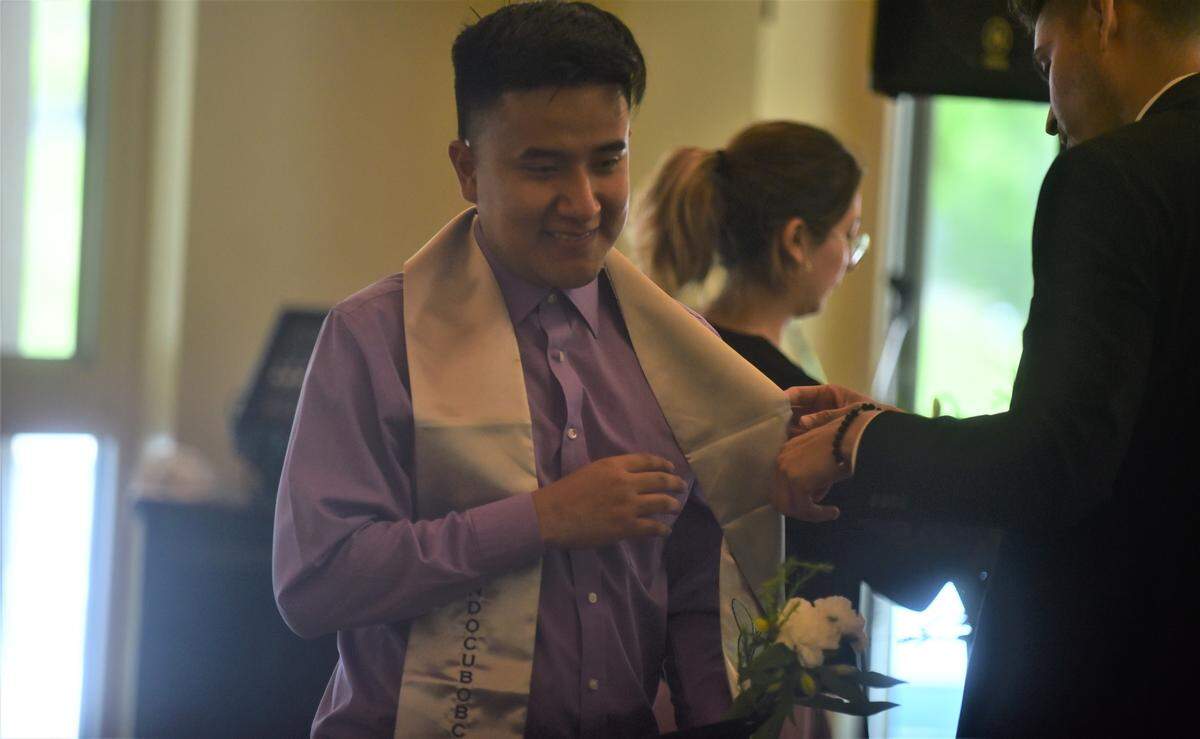 UC Merced student Edgar Martinez receives his silver undocumented stole during a celebration recognizing UC Merced undocumented students who are graduating this weekend on Friday, May 13, 2022 at UC Merced in Merced, Calif.