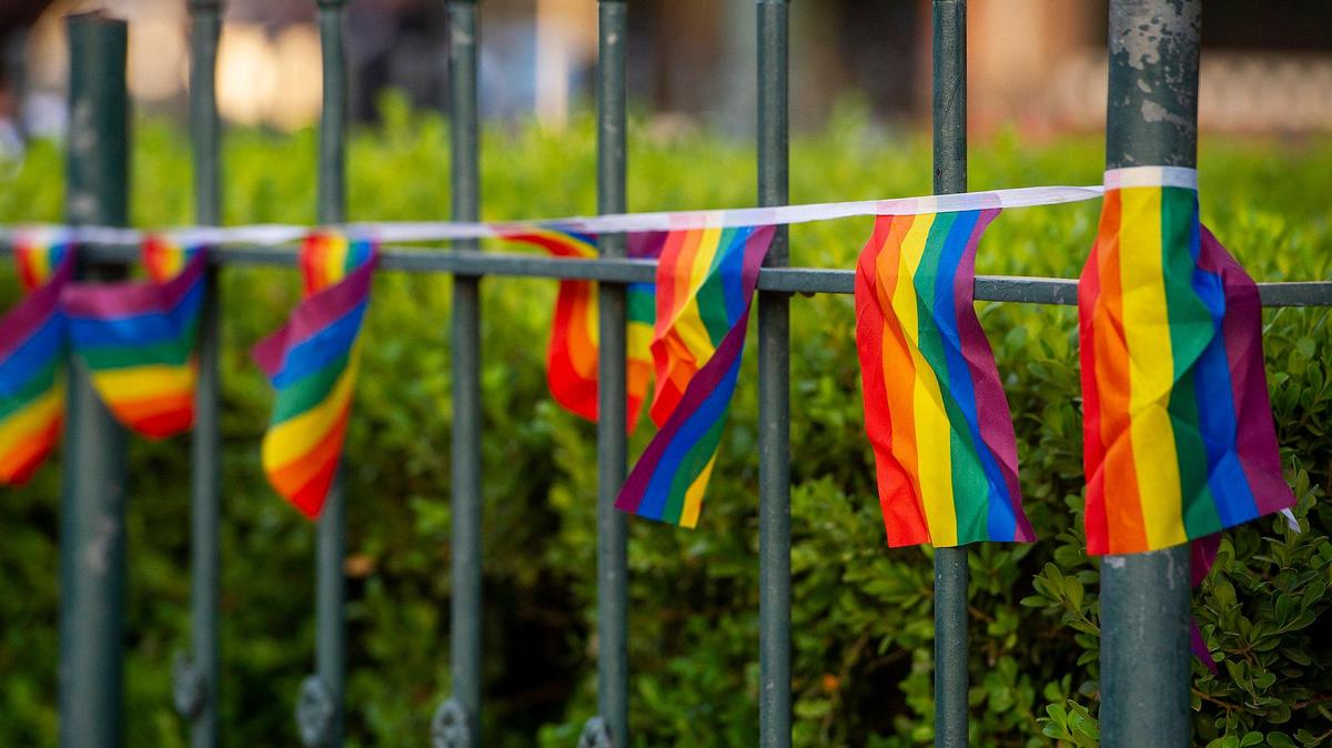 Pride flags wrapped around the fencing during a ceremony to celebrate the raising of the Progress Pride flag at Bob Hart Square in Merced, Calif., on Tuesday, June 1, 2021.