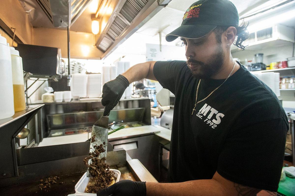 Chayanne Valencia, 33, son of owner Enrique Valencia, prepares an order at Maria’s Taco Shop in Merced, Calif., on Tuesday, Oct. 15, 2024. The restaurant which is open 24 hours, has offered authentic fast Mexican food to the Merced community for 32 years.