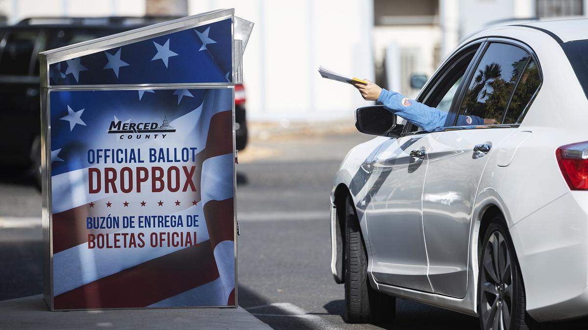 A motorist drives up to a Merced County ballot drop box outside the Merced County Administrative Building in Merced, Calif., on Tuesday, Nov. 5, 2024.