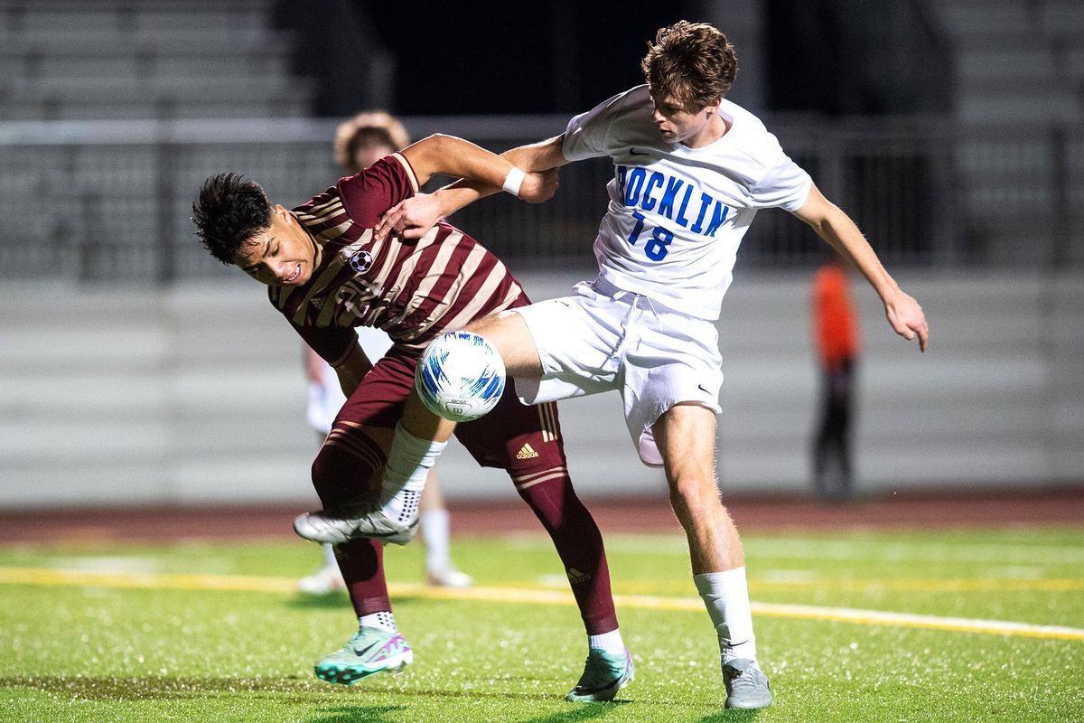 Golden Valley junior Jose Ontiveros (24) battles for possession of the ball with Rocklin sophomore Jovan Radovic (18) during a Division 2 playoff game at Golden Valley High School in Merced, Calif., on Tuesday, Feb. 13, 2024. The Cougars beat the Thunder 3-0.