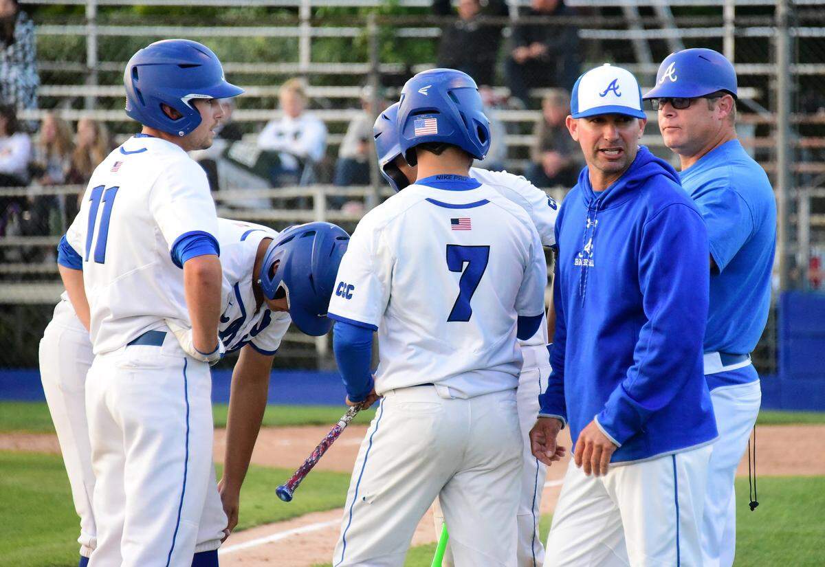 Atwater High coach Jarrod Pimentel speaks with baserunners during a break in the action on Friday night against Manteca in the Sac-Joaquin Section Division III playoffs at Memorial Ballpark in Atwater, Calif.