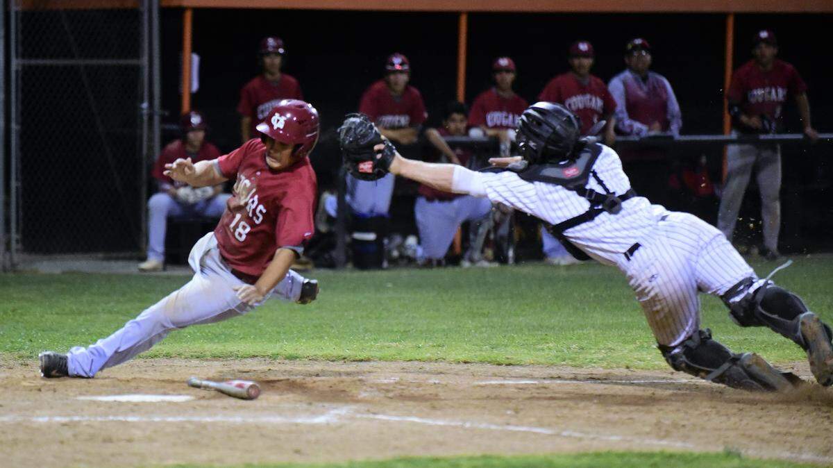 Golden Valley senior Jesus Leon avoids the tag of Merced catcher Grant Deal during a squeeze play that scored the winning run in the seventh inning in the Cougars’ 2-1 win over Merced on Friday, May 3, 2019 at Merced High.