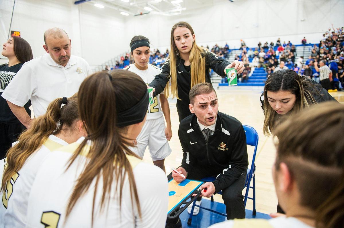 Buhach Colony coach Kevin Aguia speaks to his players during a game against Atwater at Atwater High School in Atwater, Calif., on Thursday, Jan. 17, 2019.