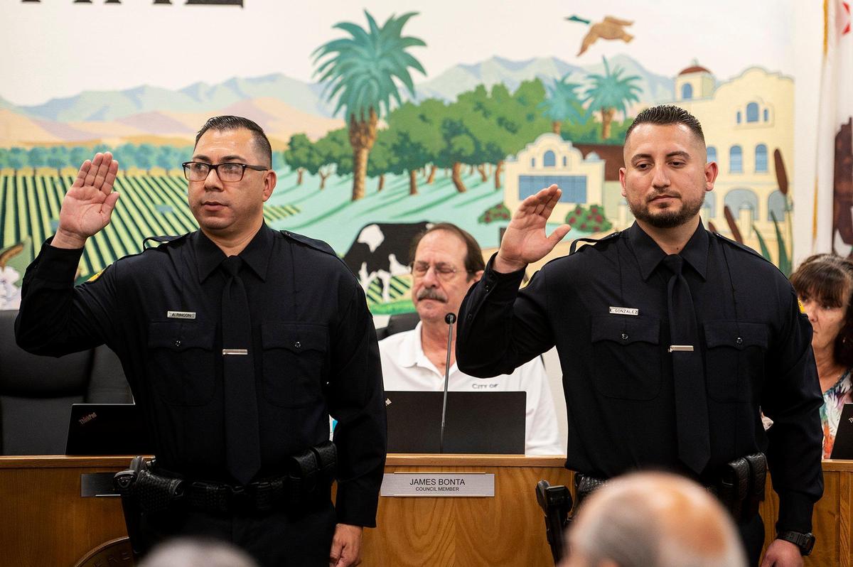 Gustine Reserve Officers Arthur Rincon, left, and Emanuel Gonzalez, right, are sworn in during a swearing in ceremony for four new Gustine Police Department Reserve Officers in Gustine, Calif., on Tuesday, June 20, 2023.