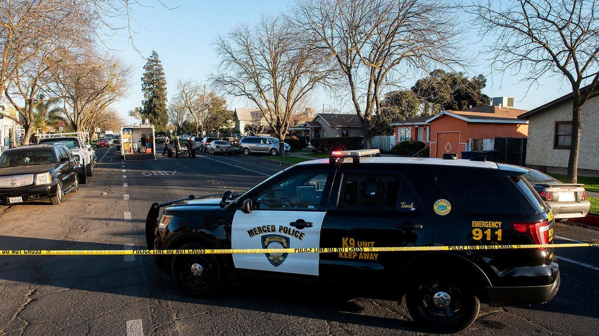 Police investigate a shooting in the 600 block of West 11th Street, that left a 22-year-old man dead in Merced, Calif., on Wednesday, Feb. 10, 2021. A 14-year-old male suspect was arrested by officers running from the scene, according to the Merced Police Department. The victim was pronounced dead at an area hospital.