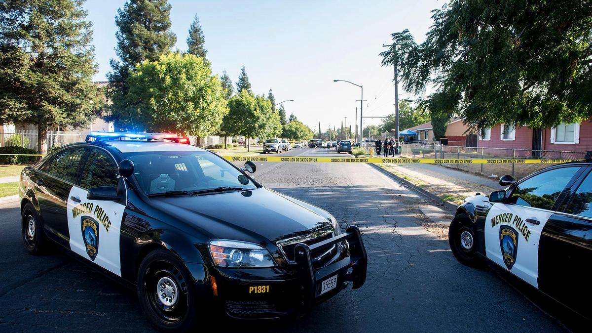 Merced Police are seen on D Street between 10th Street and 9th Street in Merced Calif., on Tuesday, Aug. 20, 2019. According to police, officers responded to the area of 11th Street and D Street Tuesday for a report of a gunshot victim.