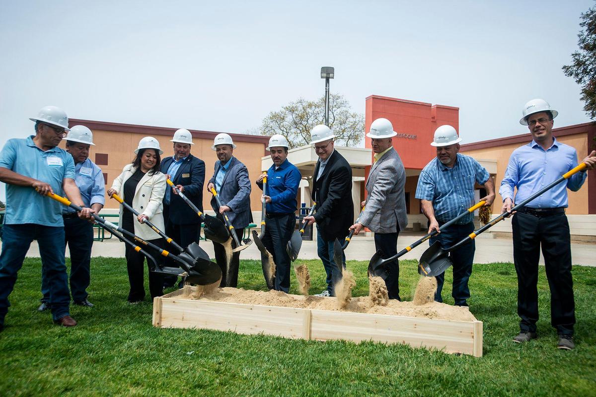 Comcast representatives are joined by school officials, community advocates and elected leaders for a ceremonial groundbreaking following the announcement of a $4.5 million investment to bring high-speed internet and broadband services to the area, at Cesar E. Chavez Middle School in Planada, Calif., on Monday, April 17, 2023. According to Nathan Ahle, Comcast Director of Government Affairs for the South Valley, the $4.5 million investment involves extending the existing network from nearby Merced into the town of Planada.