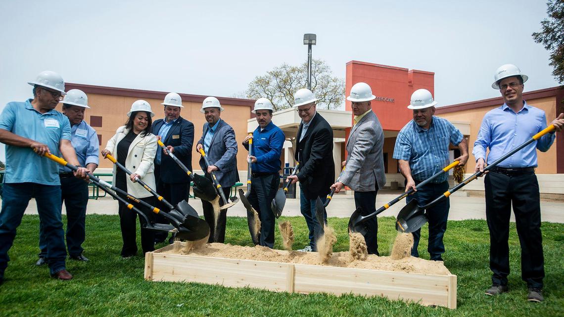 Comcast representatives are joined by school officials, community advocates and elected leaders for a ceremonial groundbreaking following the announcement of a $4.5 million investment to bring high-speed internet and broadband services to the area, at Cesar E. Chavez Middle School in Planada, Calif., on Monday, April 17, 2023. According to Nathan Ahle, Comcast Director of Government Affairs for the South Valley, the $4.5 million investment involves extending the existing network from nearby Merced into the town of Planada.