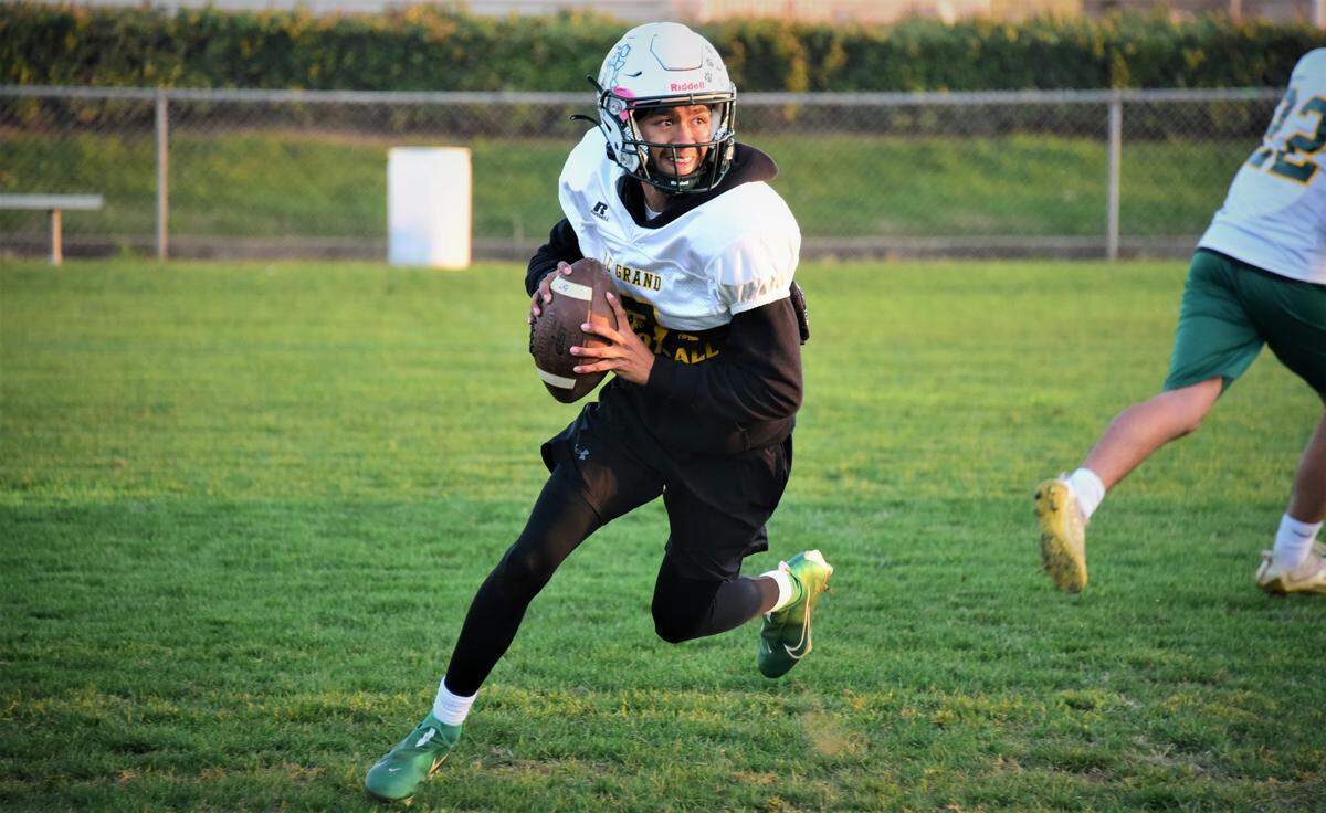 Le Grand High junior Julian Bucio rolls out during practice on Wednesday, Dec. 1, 2021 at Le Grand High School in Le Grand, Calif.