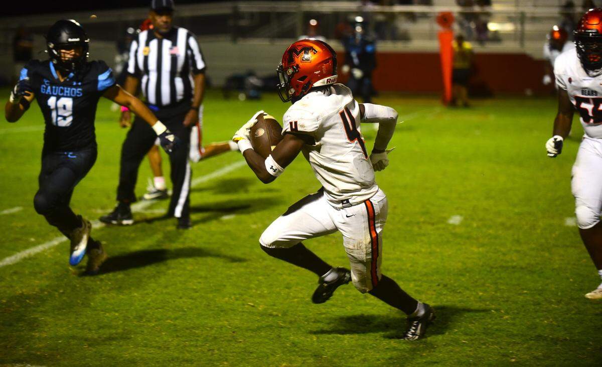 Merced High School senior running back Chase Smith (4) runs the ball during a game against El Capitan on Friday, Oct. 6, 2023. Smith rushed for 200 yards and two touchdowns in a 56-7 win over the Gauchos.