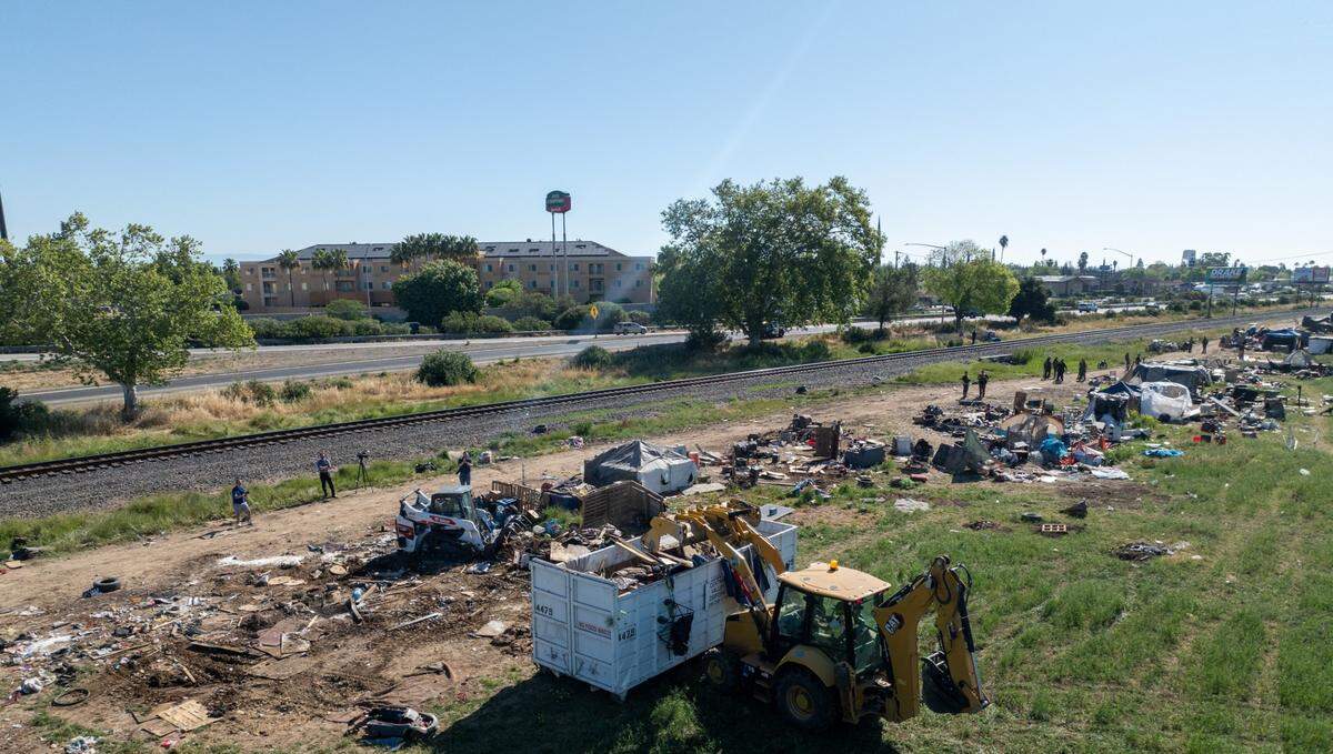 Merced County officials partnered with other local agencies to tear down a large homeless encampment located near East Childs Ave. and Highway 99 this week in Merced.