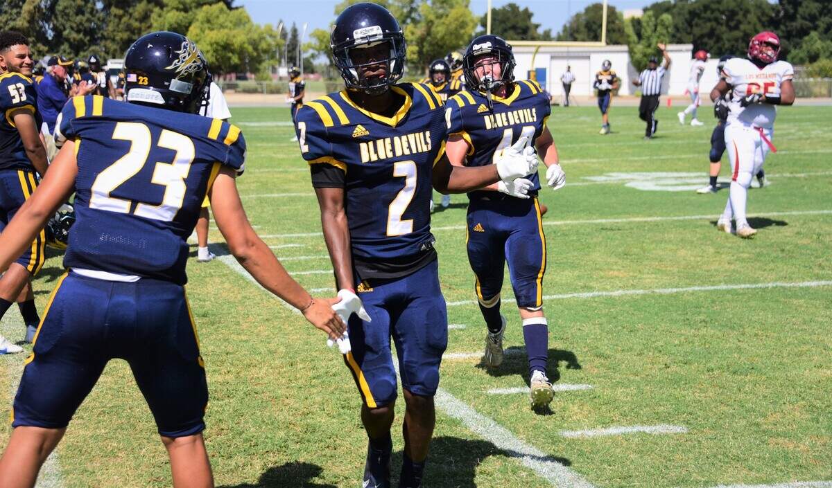 Merced College cornerback Alfonso Gary (2) is congratulated by teammate Isaac Soliz (23) after Gary intercepted a pass during a game against Los Medanos on Saturday, Sept. 11, 2021 at Don Odishoo Field in Merced, Calif.