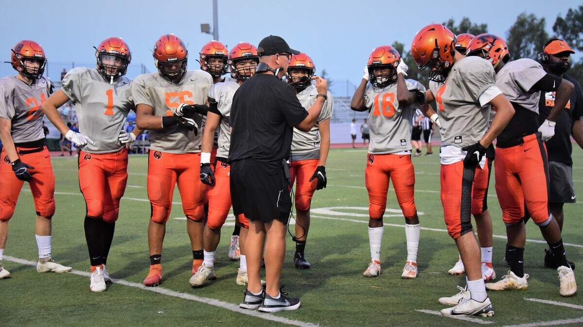Merced coach Rob Scheidt (center) talks to the Bears offense during a scrimmage against Clovis on Friday, Aug. 13, 2021 at Veterans Stadium in Merced, Calif.