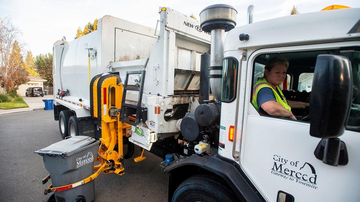 Merced Refuse Equipment Operator Kristie Light, 56, drives her route collecting refuse in Merced Calif. on Thursday, Oct. 24, 2024. According to Light who previously drove commercial trucks across parts of the country and would routinely be gone for 70-80 hours a week, her current job with the city allows her to spend more time at home. “It’s nice to go to work and like your job,” said Light.