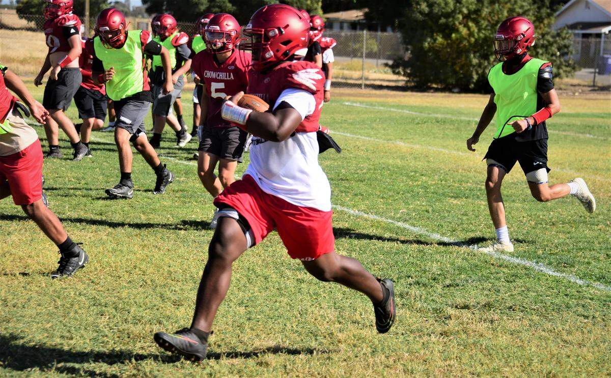 Chowchilla High School sophomore Dwayne Hemphill runs the ball during practice on Wednesday, Aug. 10, 2022.