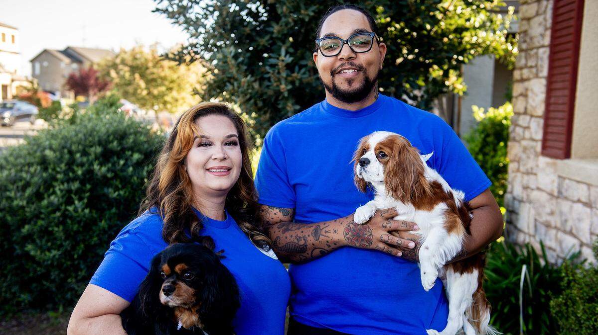 Tiffany Picton, left, with her husband Devin Picton, right, and two of their dogs, in Merced, Calif., on Thursday, April 3, 2025. The business the couple started together, Tha Bomb Squad, provides dog waste removal services.