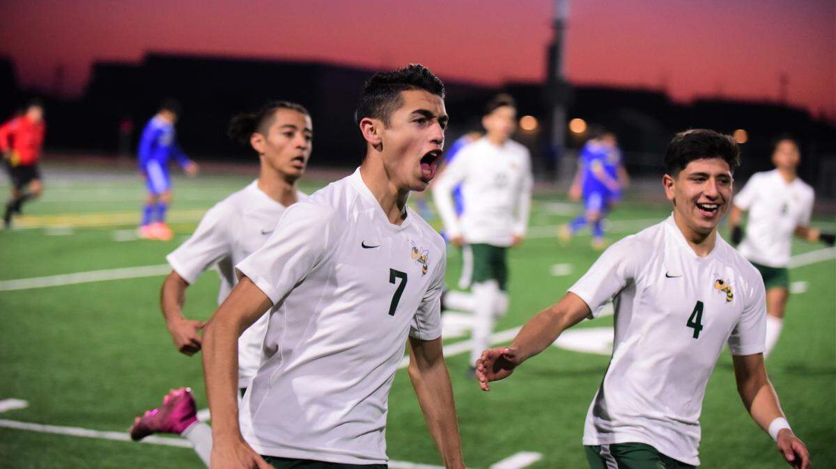 Hilmar High senior Marc Matos celebrates with teammate Randy Lozano (4) after scoring a goal on a penalty kick in overtime during the Sac-Joaquin Section Division V championship with a 5-4 overtime win over Linden at Liberty Ranch High School in Galt, Calif. on Saturday, Feb. 22, 2020.