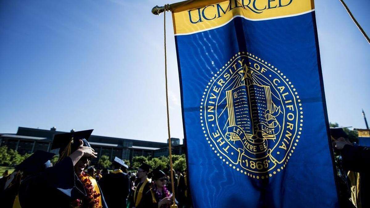 University of California, Merced graduates gather at the campus sculpture titled “Beginnings” prior to the commencement ceremony for the School of Engineering and the School of Natural Sciences.