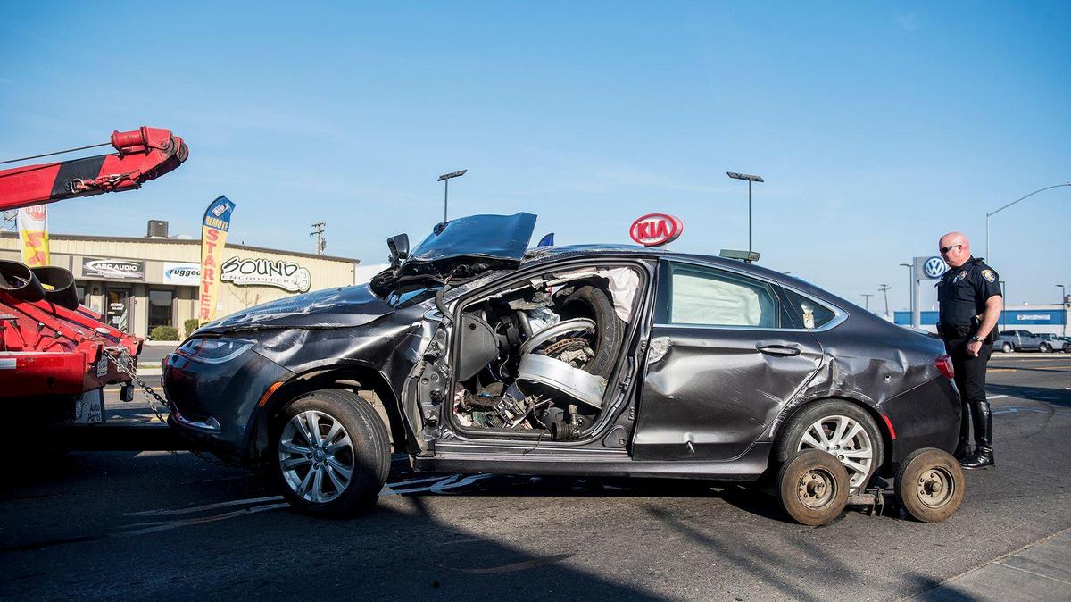 A vehicle is removed from the scene of a rollover collision in the 1500 block of West 16th Street in Merced, Calf., on Wednesday, Feb. 12, 2020. According to Merced Police, firefighters removed the man who was pinned inside the vehicle following the collision. He was transported to a Modesto area hospital with unknown injuries, police said.
