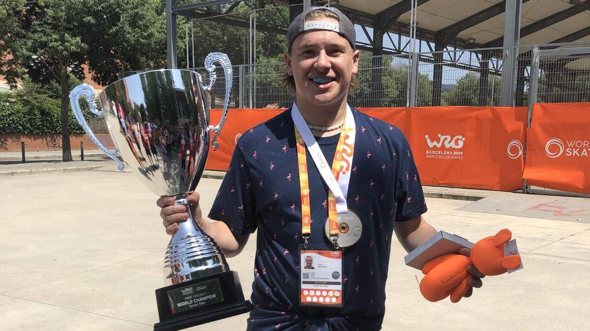 Merced’s Tyler Van Winkle holds the trophy and wears his gold medal after helping the Mens USA Roller Derby Team win the World Roler Games in Barcelon, Spain.