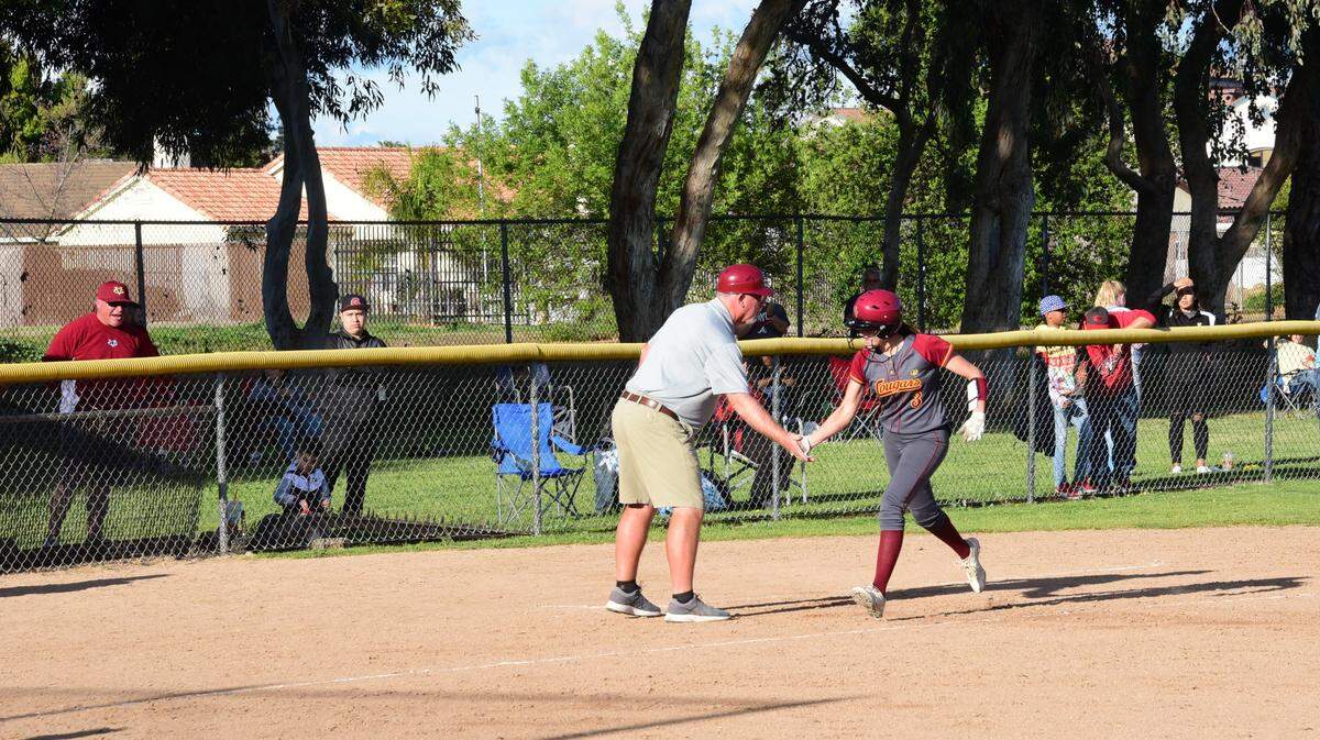 Golden Valley senior Marissa Bertuccio celebrates her second home run on Friday against Merced with Cougars coach Ross Cruickshanks. Golden Valley defeated Merced 7-2 to improve to 5-0 in the Central California Conference.