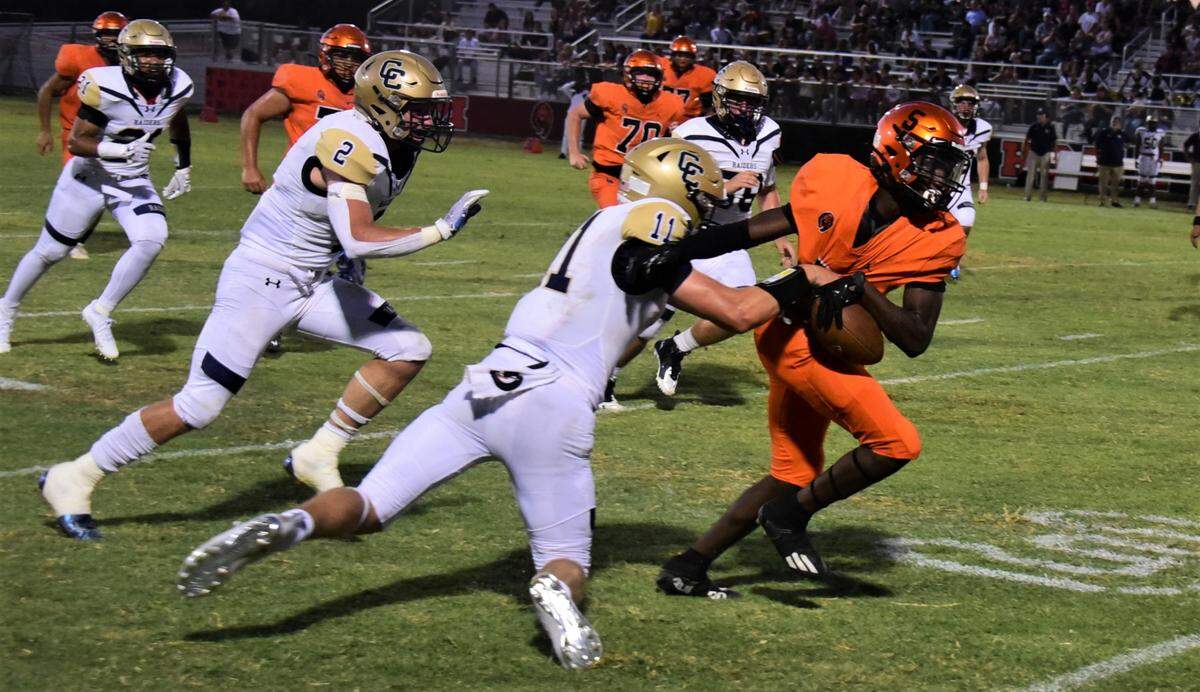 Central Catholic’s TP Wentworth tries to bring down Merced High running back Chase Smith during a game on Friday, Aug. 19, 2022 at Cathie Hostetler Stadium in Merced, Calif.