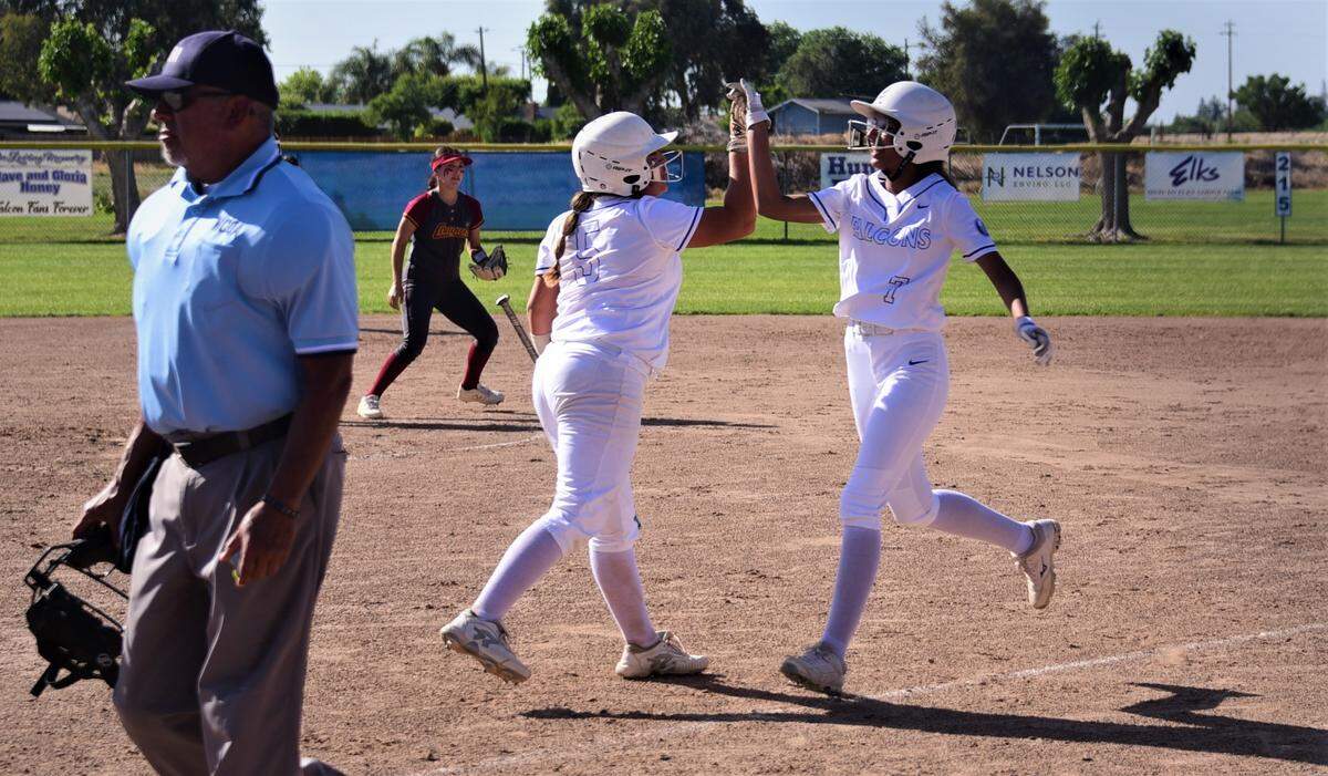 Atwater High senior Amelia Valdez (left) congratulates teammate Zitlaly Zepeda after she scored on Zepeda’s squeeze bunt during a 2-1 win over Golden Valley on Tuesday, May 3, 2022 at Atwater High School.