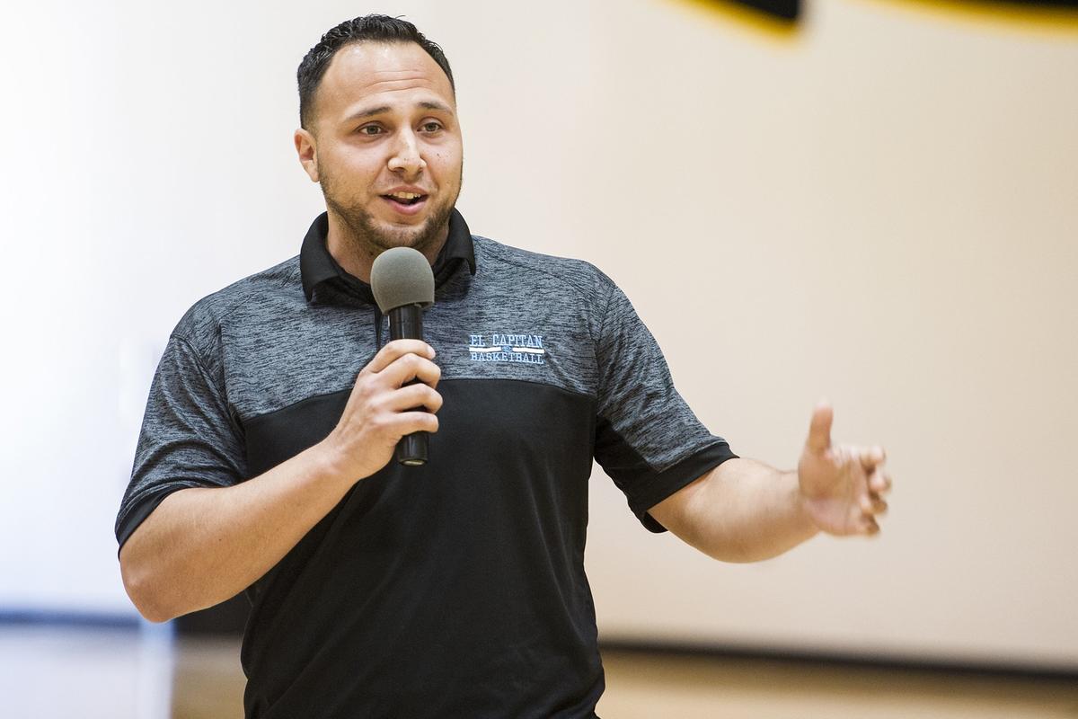 El Capitan boys varsity basketball coach Adrian Hurtado, speaks during a ceremony for senior Angel Serena at El Capitan High School in Merced, Calif., on Friday, April 27, 2018. Serena signed his letter of intent to attend and play basketball for the University of California, Merced.