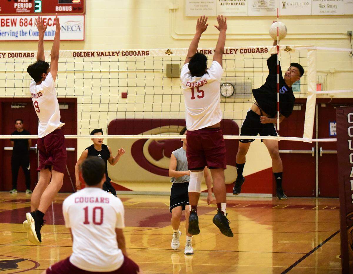 El Capitan senior Jace Taylor strikes the ball as a Golden Valley’s Mateo Tanaagan goes up for the block. The Cougars swept the Gauchos 3-0.