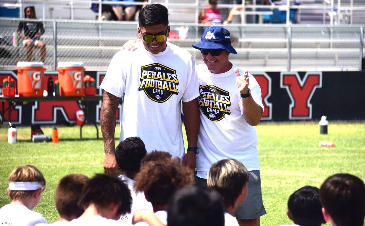 Pittsburgh Steelers linebacker David Perales (left) and Merced High School football coach Rob Scheidt share a laugh while talking to campers at the David Perales Football Camp held at Merced High School on Saturday, July 13, 2024 in Merced, Calif.