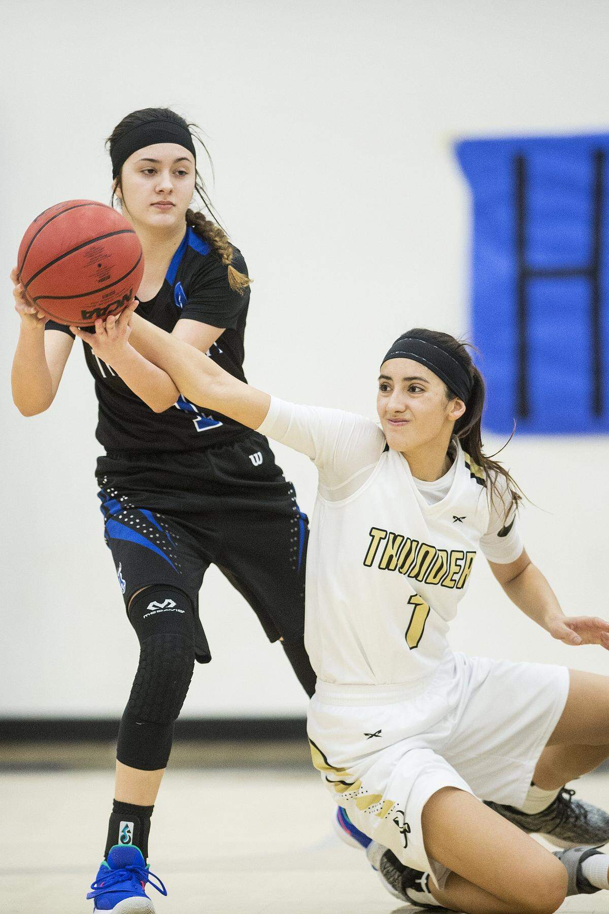 Atwater senior Kelsey Valencia (1), left, and Buhach Colony junior Caly Curran (1), right, fight for possession fo the ball during a game at Atwater High School in Atwater, Calif., on Thursday, Jan. 17, 2019.