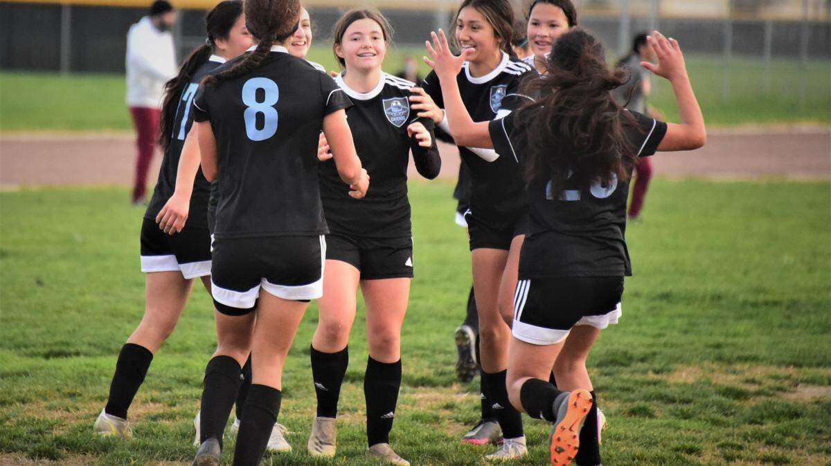 El Capitan sophomore Abigail Hratchian is surrounded by her teammates after she scored the game-winning goal in a 2-1 win over Golden Valley during a match on Friday, January 7, 2022 at El Capitan High School in Merced, Calif.
