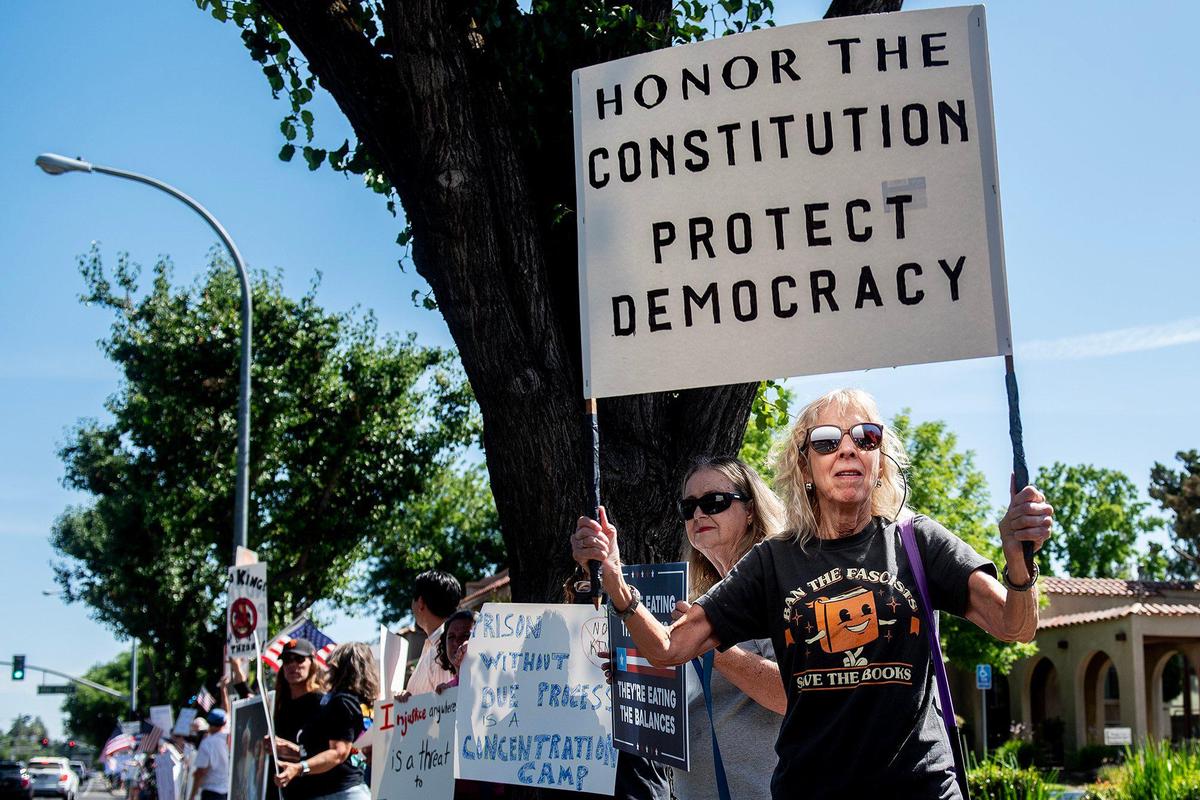 A woman who identified herself as Jennifer, holds a sign as she and other protesters take part in a “No Kings” protest in Merced, Calif., on Saturday, June 14, 2025. “This country is heading in the wrong direction,” Jennifer said. “We’re not being run on democracy, a democracy is not run by executive orders.” Jennifer went on to say “our rights are being taken away slowly, so I feel it’s very important to be out here, express our concerns.” Jennifer said she attended another protest about a month ago and Saturday’s protest appeared to be much larger. “It really makes me proud to see Mercedians coming out and no matter what they’re supporting, but coming out and supporting democracy,” she said.
