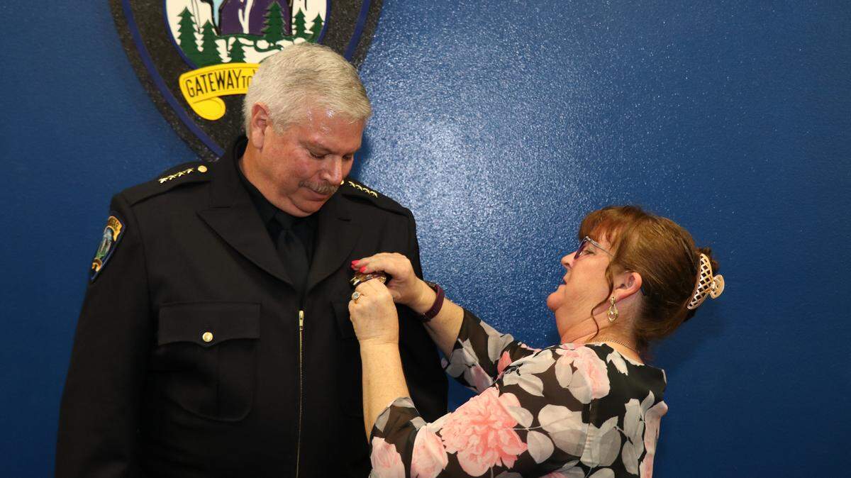 New Merced Interim Police Chief Tom Cavallero is shown with his wife Wendy, who pinned the badge on his uniform during a brief swearing-in ceremony Tuesday.