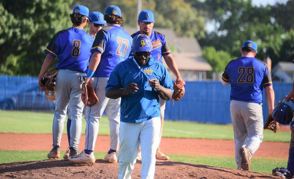 Dos Palos High School baseball coach Leonard Davis leaves the field after a visit to the mound during the Central Section Division III semifinal playoff game against Dinuba on Tuesday, May, 23, 2023 at Dos Palos High School.