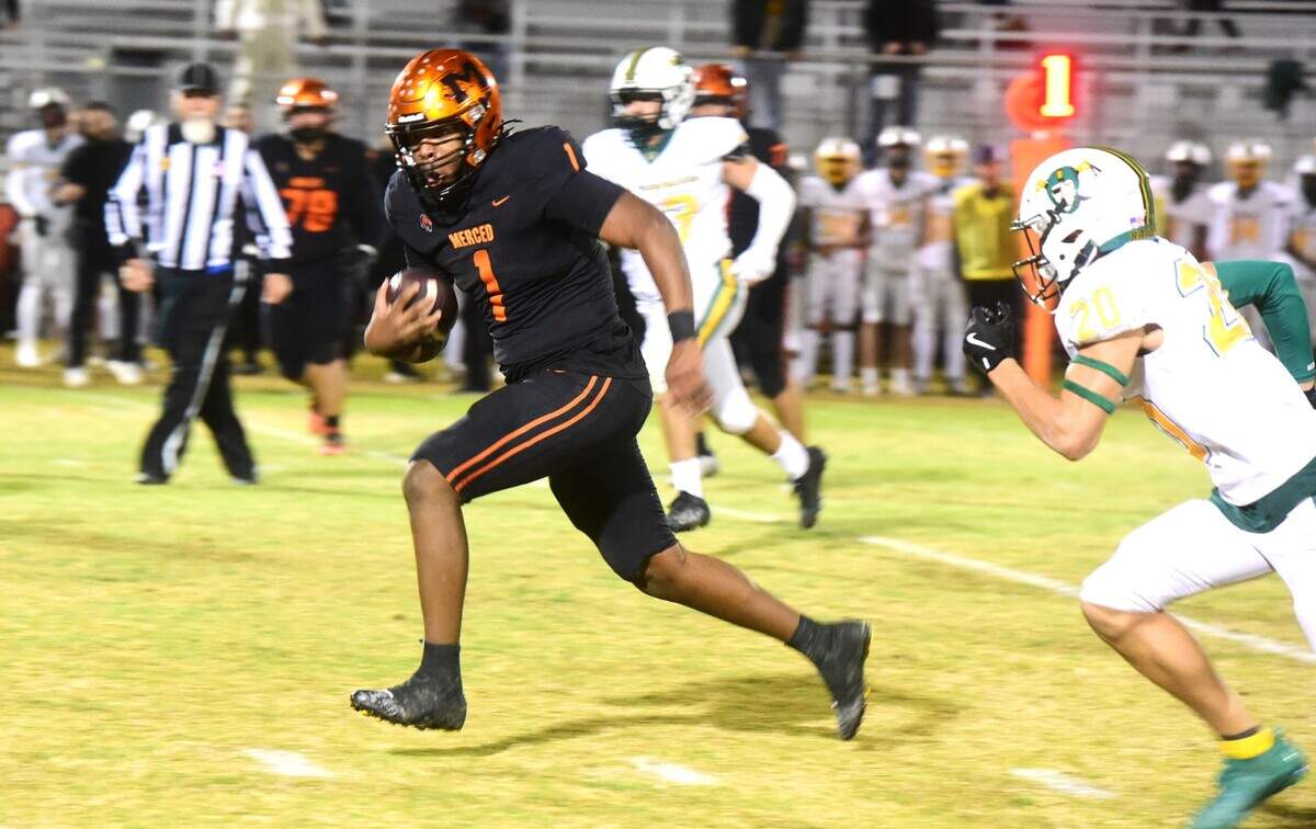 Merced High quarterback Quintell Dupree (1) makes a run for a first down during a playoff game against Rio Americano on Friday, Nov. 8, 2024 at Cathie Hostetler Stadium in Merced, Calif.
