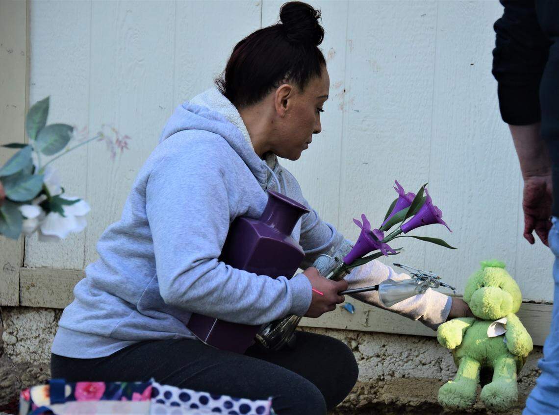 Victoria Lopez of Los Banos decorates a flower bed in memory of her daughter Tatyanna Lopez, who was killed one year ago in Merced, on Monday, April 18, 2022 in Merced, Calif.