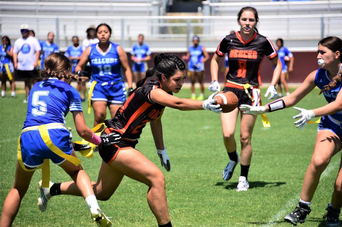 Merced High School receiver Rosalie Guevara (24) extends the ball out after making a catch against Atwater during a flag football game on Saturday, Aug. 19, 2023 at Merced High School in Merced, Calif.