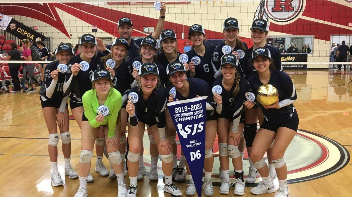 The Stone Ridge Christian High girls volleyball team shows off their second straight Sac-Joaquin Section Division VI blue banner after a three-game sweep of Forest Lake Christian on Saturday, Nov. 9, 2019 at Ripon High School.
