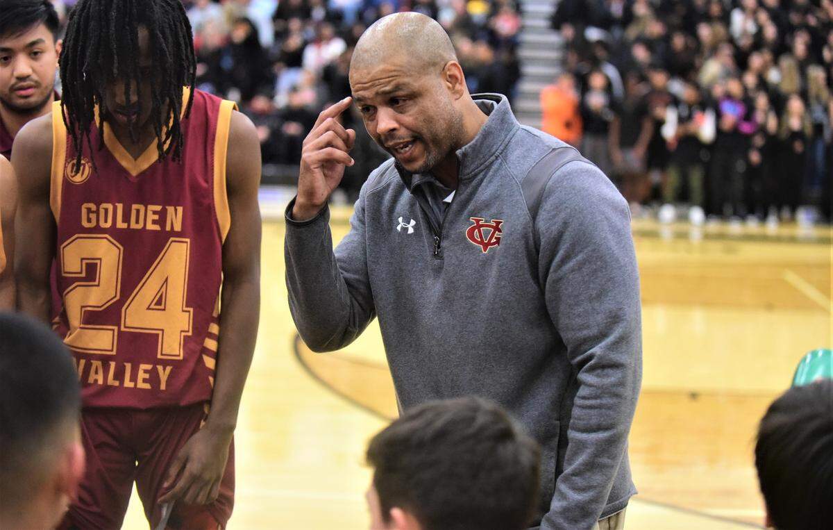 Golden Valley High School boys basketball coach Derrick Jacobs talks to his players during a timeout in a game against Merced on Friday, Jan. 20, 2023 at Merced High School.