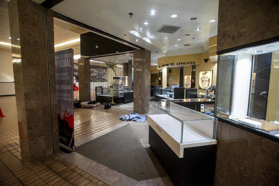 Work is performed inside Prestigio Jewelers at the Merced Mall in Merced, Calif., on Thursday, Feb. 10, 2022, as the business prepares to reopen after thieves stole more than $100,000 in merchandise during a smash-and-grab robbery two days earlier.