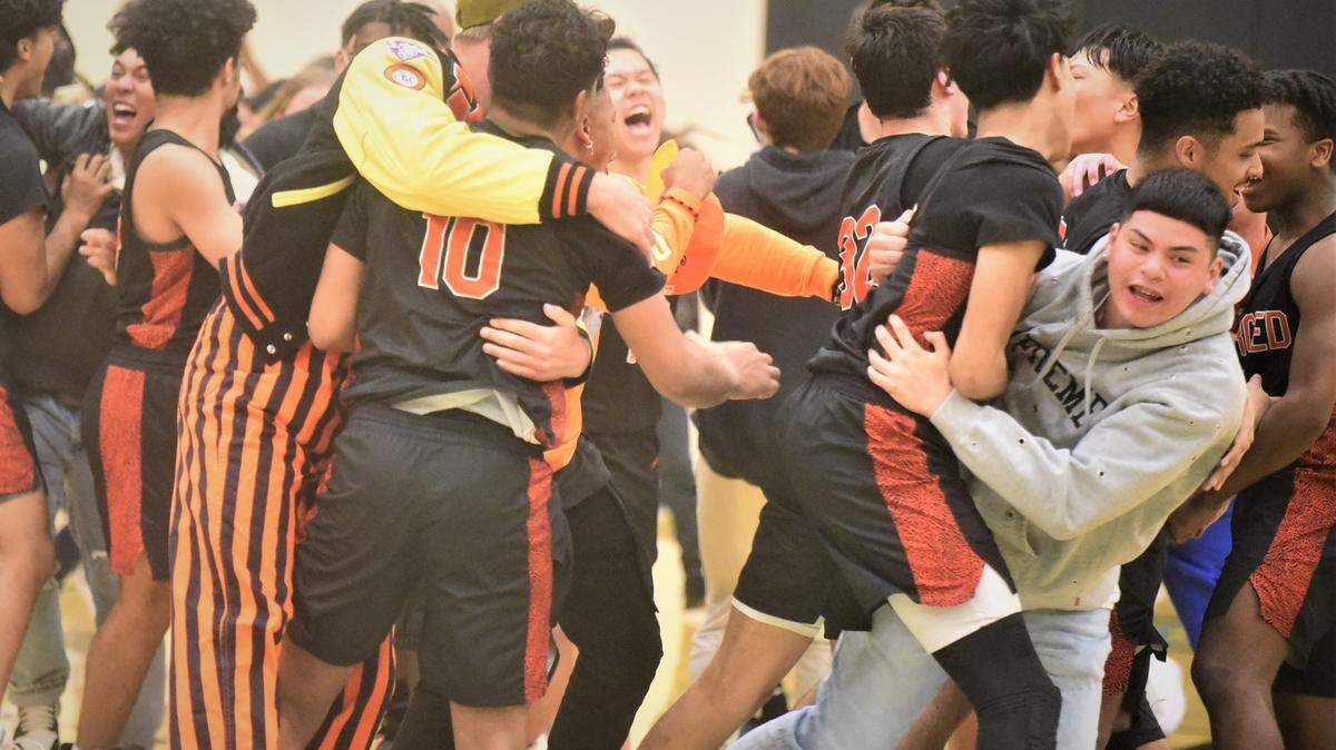 The Merced High players and students celebrate a 49-45 victory over El Capitan on Monday, Feb. 7, 2022.