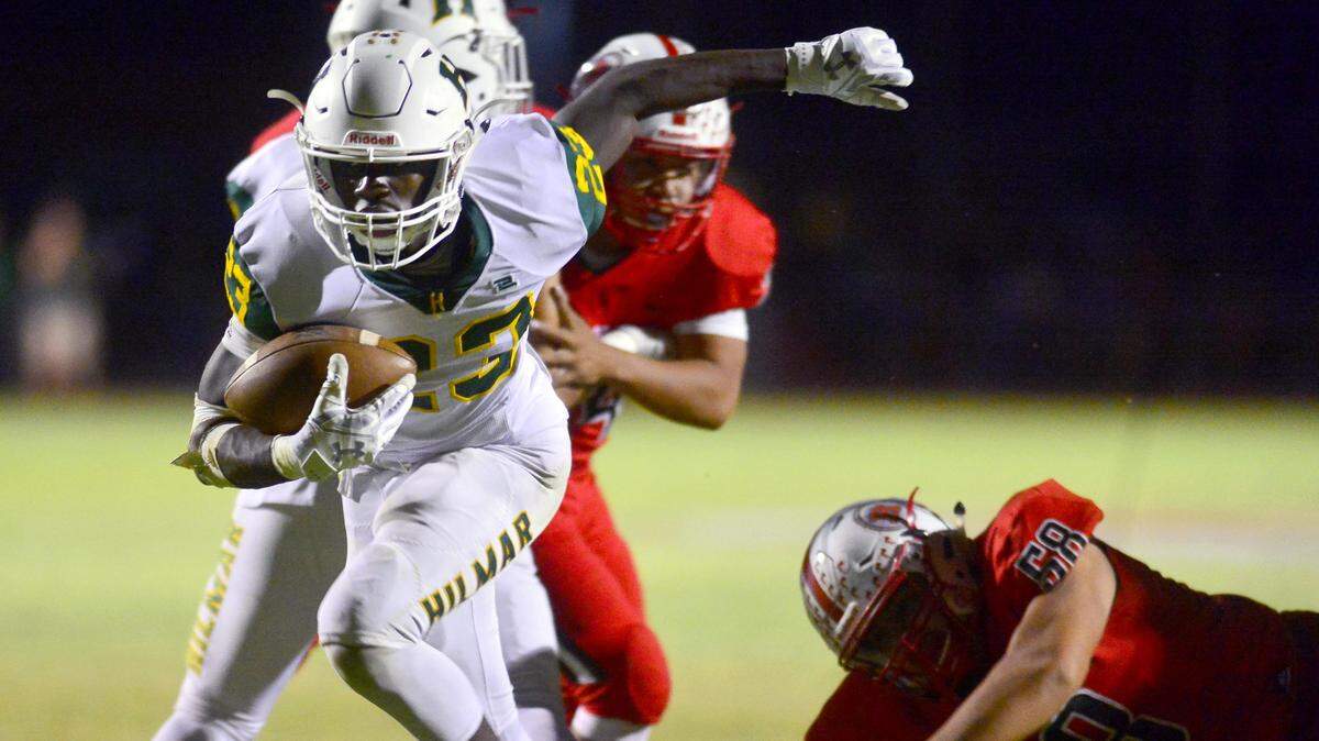 Hilmar running back Issac Sharp leans forward as he scores a touchdown during a game between Ripon and Hilmar at Ripon High School in Ripon CA on September 14, 2018.

