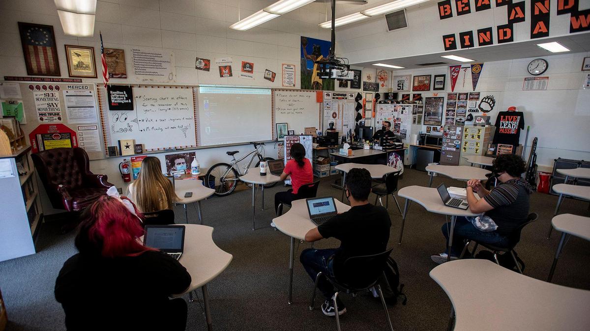 Merced High School 11th grade U.S. History teacher Jacob Meneley, speaks to students in the classroom and online at Merced High School in Merced, Calif., on Thursday, April 22, 2021.